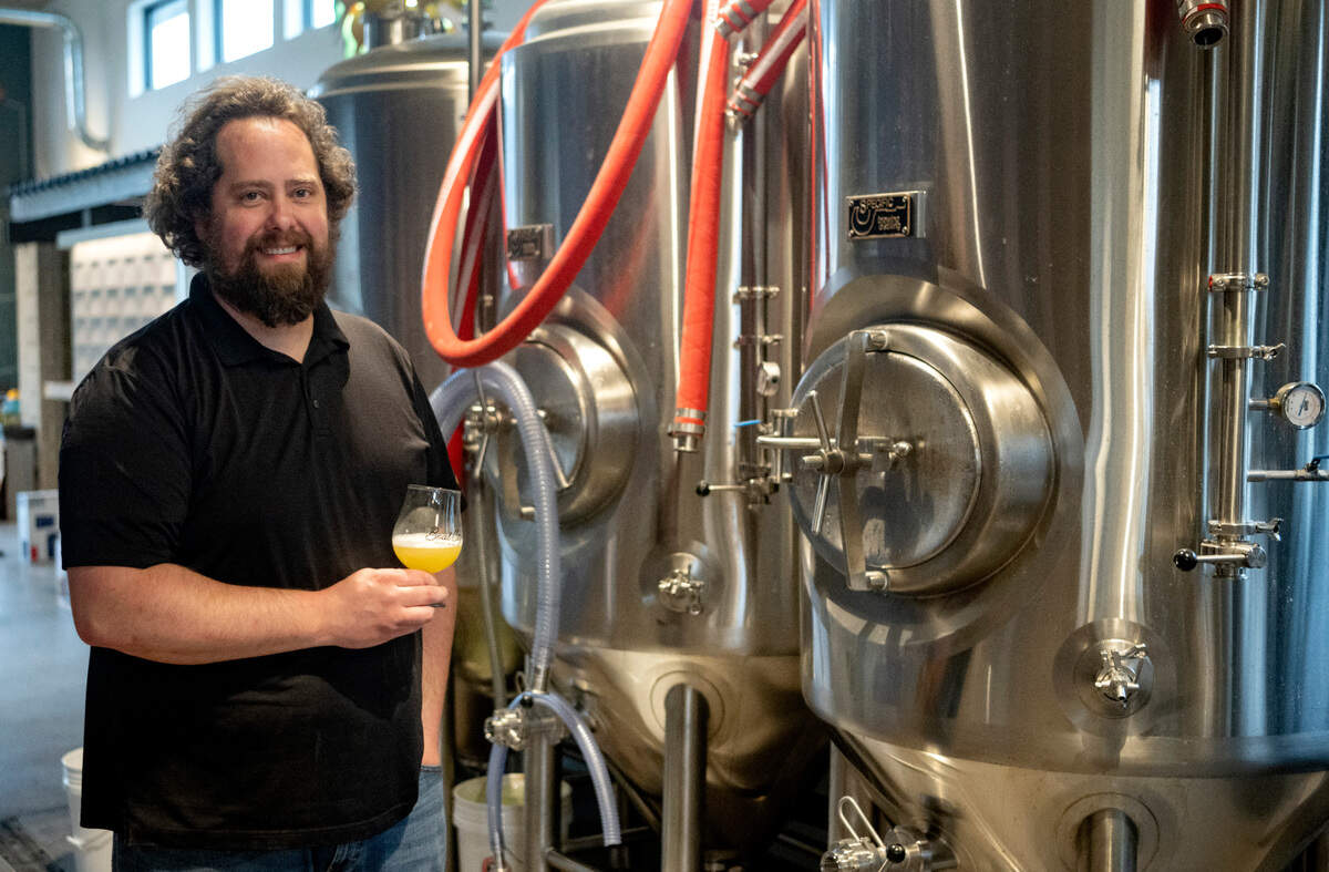 Brewer Mike Smith with a sample of a hazy IPA at Boal City Brewing on Friday, March 31, 2023.
