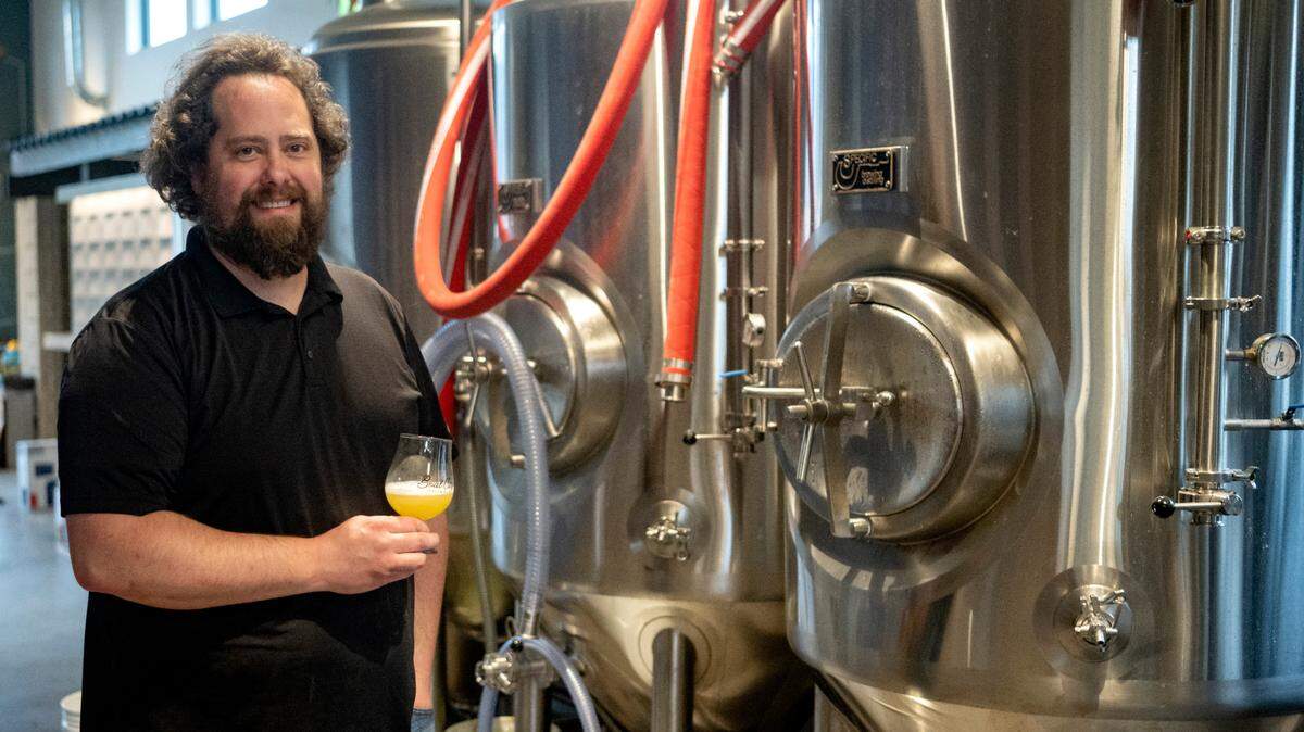 Brewer Mike Smith with a sample of a hazy IPA at Boal City Brewing on Friday, March 31, 2023.