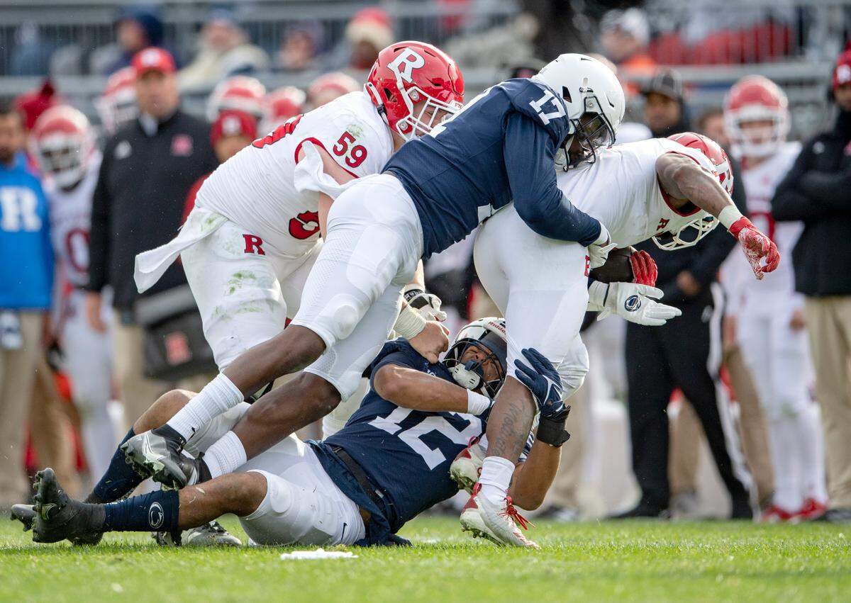Penn State linebacker Brandon Smith and defensive end Arnold Ebiketie stop Rutgers ball carrier during the game against Rutgers on Saturday, Nov. 20, 2021.