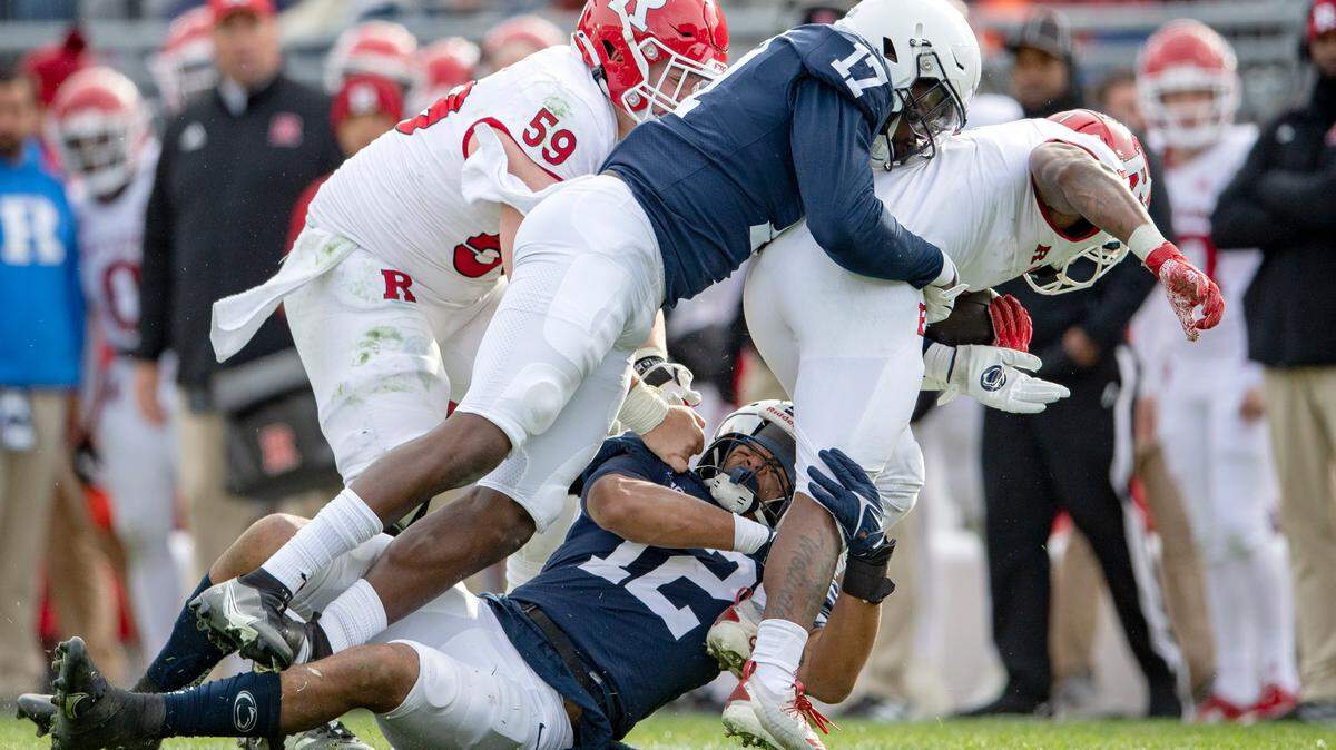 Penn State linebacker Brandon Smith and defensive end Arnold Ebiketie stop Rutgers ball carrier during the game against Rutgers on Saturday, Nov. 20, 2021.