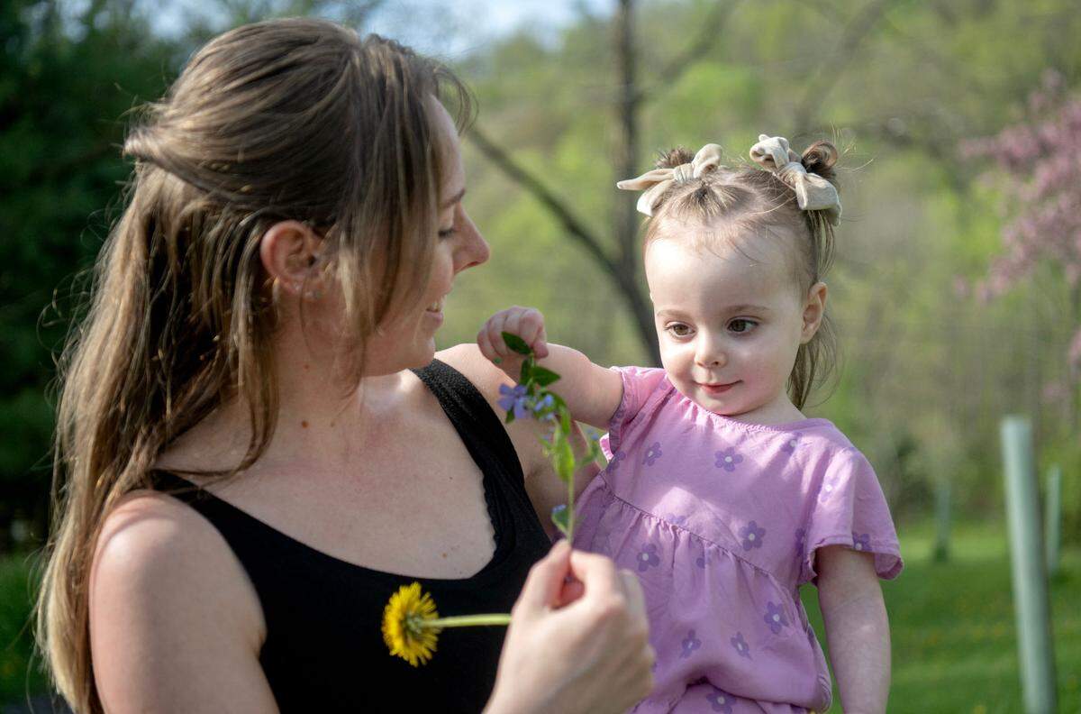 Freya Barragan picks dandelions and flowers with her mom Carly on Tuesday, April 30, 2024. Freya has Dravet Syndrome which causes seizures.