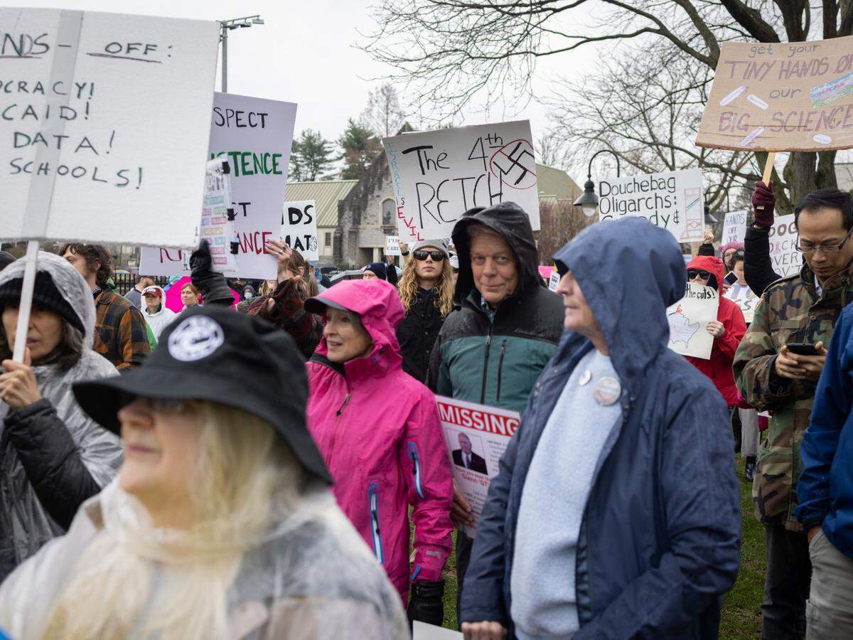 Protesters hold signs Saturday while listening to speakers at the “Hands Off!” rally at State College’s Sidney Friedman Park, in opposition of President Donald Trump. The event was part of a nationwide effort that saw more than 1,000 similar rallies held across all 50 states.