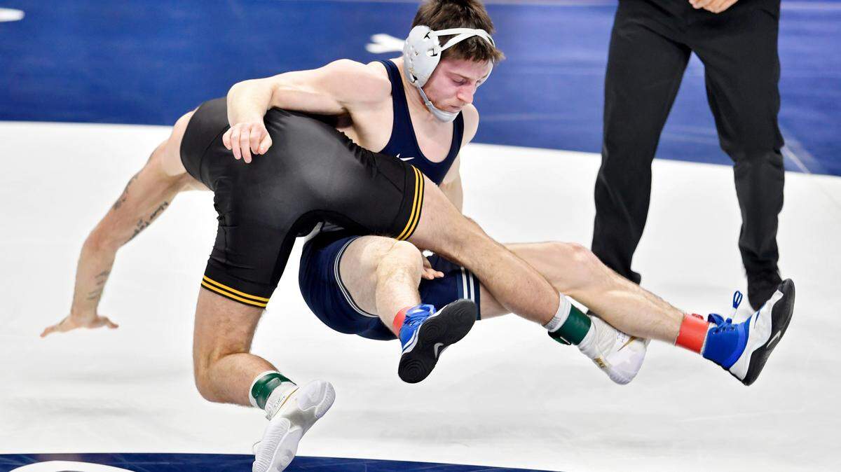 Iowa’s Jaydin Eierman and Penn State’s Nick Lee fly through the air in the 141-pound championship bout at the 2021 Big Ten Wrestling Tournament at the Bryce Jordan Center in State College, Pa, on Sunday, March 7, 2021. Eierman won by decision, 6-5.