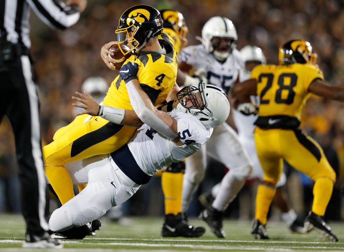 Penn State defensive tackle Robert Windsor, center, sacks Iowa quarterback Nate Stanley during the second half of an NCAA college football game Saturday, Oct. 12, 2019, in Iowa City, Iowa. (AP Photo/Matthew Putney)