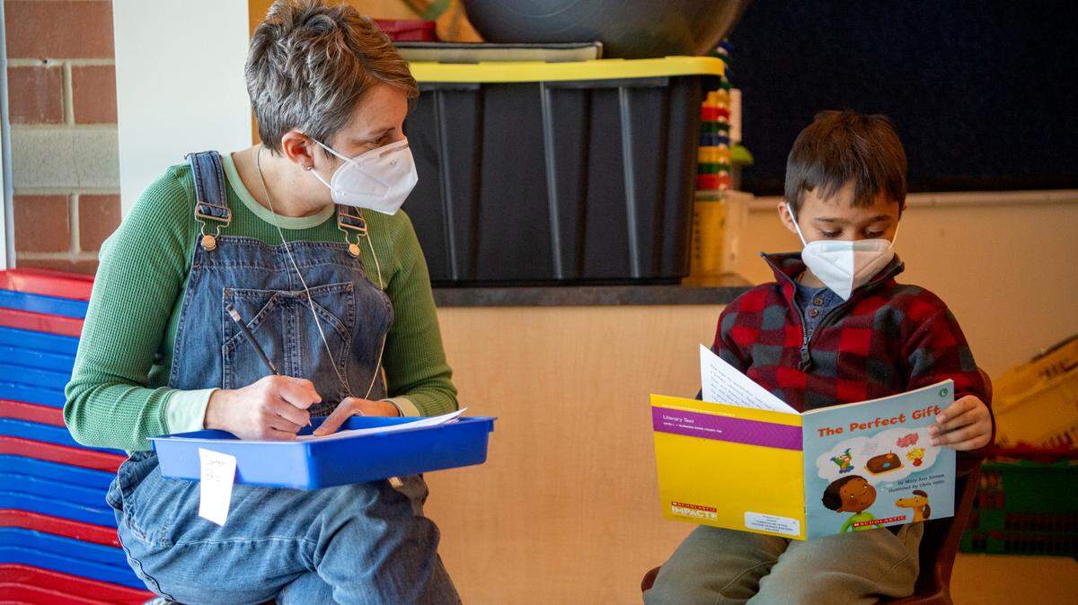 Marcie Rockey listens to one of her kindergarten students read a book at Mount Nittany Elementary in January.