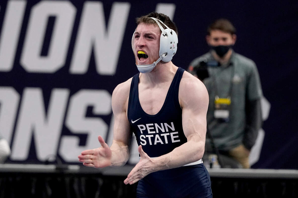 Penn State’s Nick Lee celebrates after defeating Iowa’s Jaydin Eierman during their 141-pound match in the finals of the NCAA wrestling championships Saturday, March 20, 2021, in St. Louis. (AP Photo/Jeff Roberson)