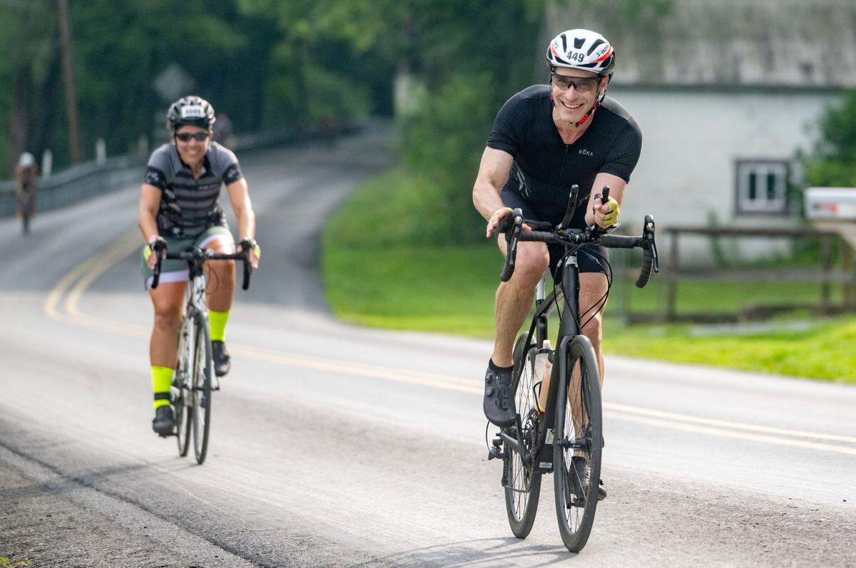 State College mayor Ezra Nanes rides along Jacksonville Road during 56 mile bike ride for the Ironman 70.3 Pennsylvania Happy Valley on Sunday, June 30, 2024.