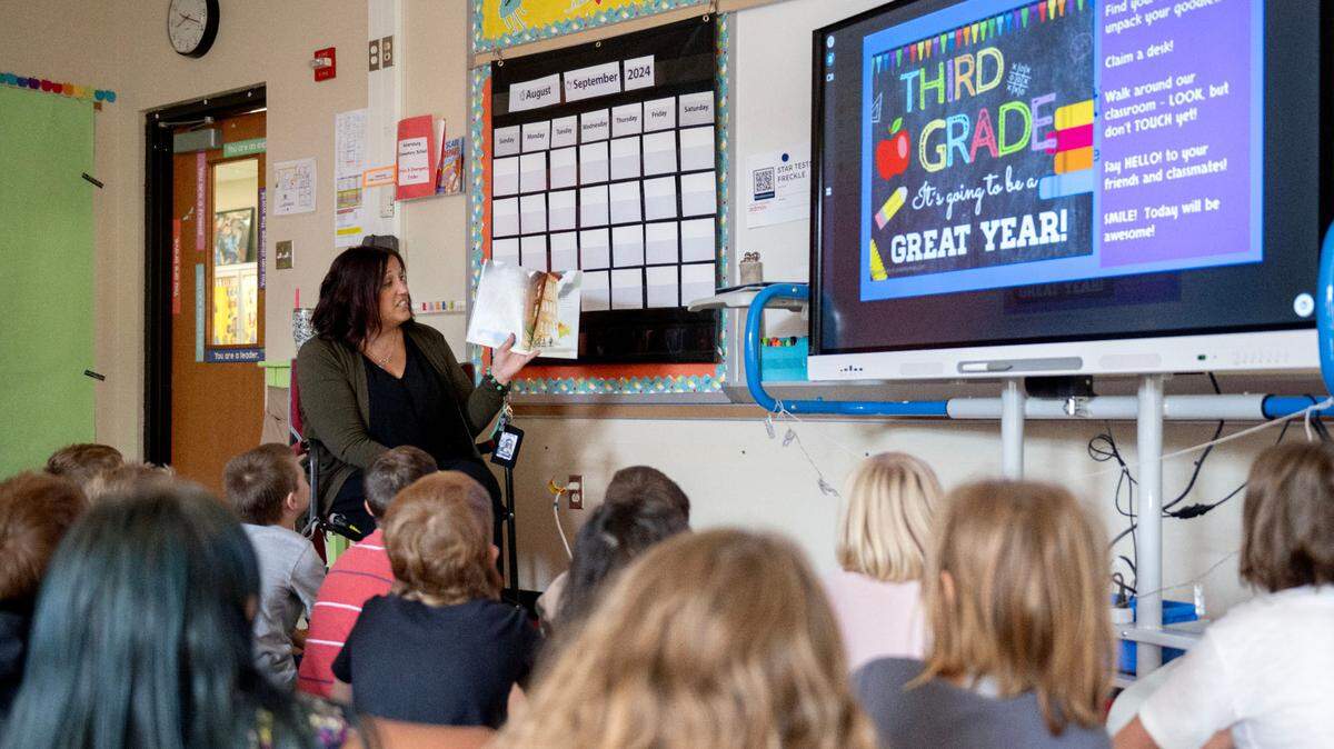Shelley Feltenberger reads a book about the first day of school to her third grade class to welcome them to the school year at Miles Township Elementary Aug. 27, 2024.  