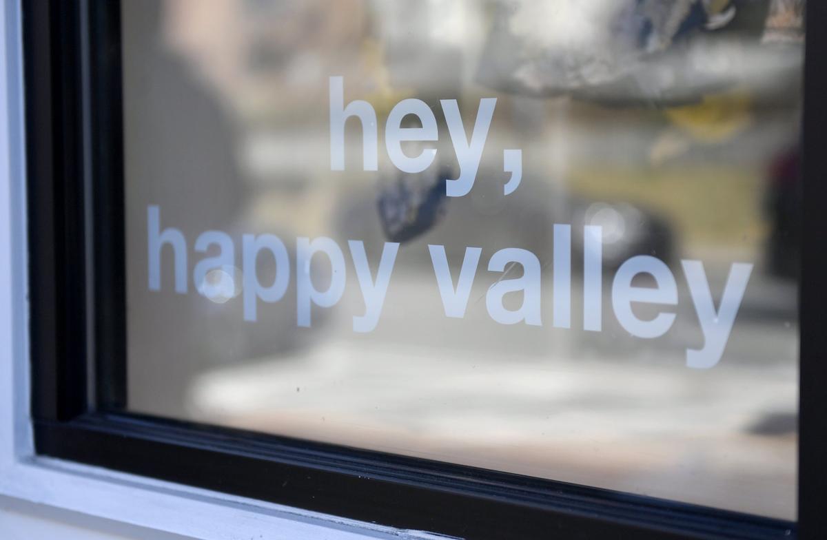 A window sticker appearing Tuesday, March 12, 2019, at Ethereal Boutique on College Avenue reads: “hey, happy valley.”