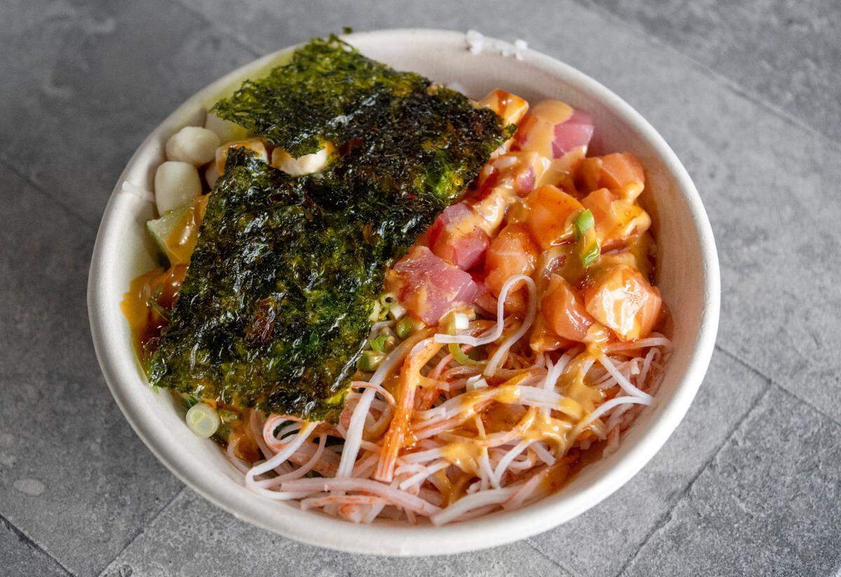 A Poke Fresh Special, which includes salmon, tuna, scallop, pineapple, cucumber, poke special, sweet chili sauce, Dani salad, seaweed salad, green onion and roasted seaweed from the new Poke Fresh on Calder Way.