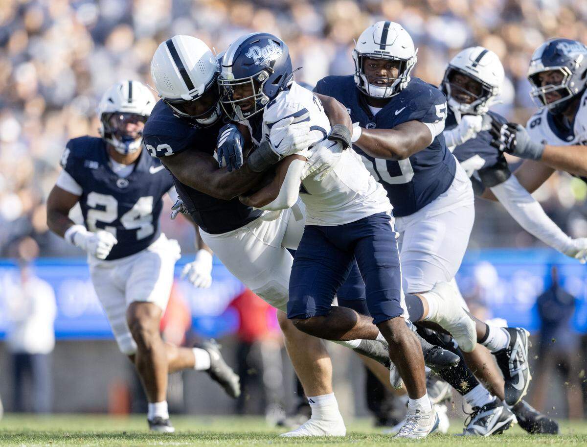 Penn State defensive end Dani Dennis-Sutton knocks the ball away from Nevada running back Herschel Turner during the game on Saturday, Aug. 30, 2025 at Beaver Stadium.