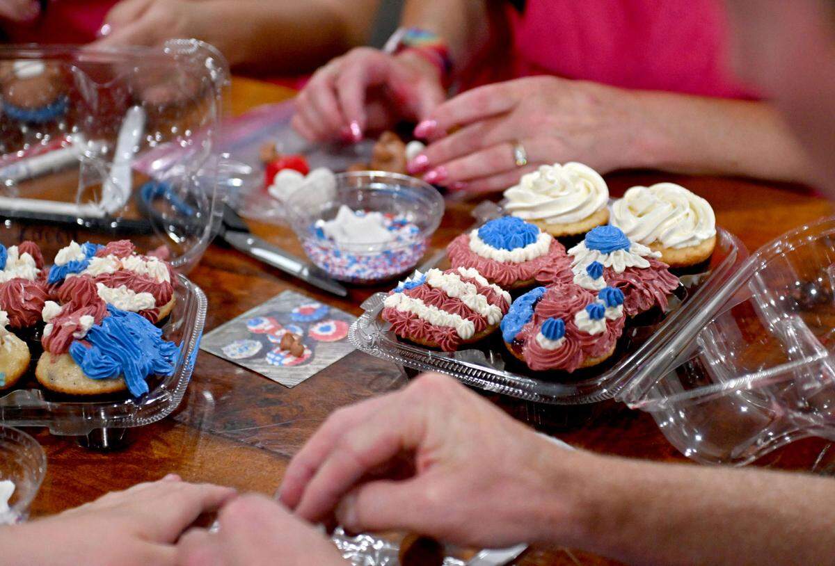 Participants of Delectable Delights’ Cupcake Caravan decorate patriotic cupcakes on Tuesday, July 9, 2024.