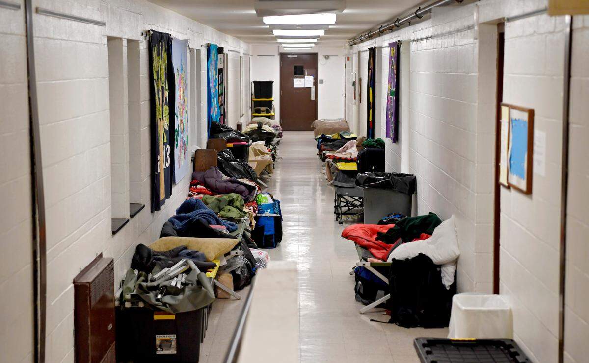 Cots and belongings line a hallway at St. Andrew’s Episcopal Church on Nov. 26. Out of the Cold: Centre County had 21 guests that evening looking for a warm place to sleep.