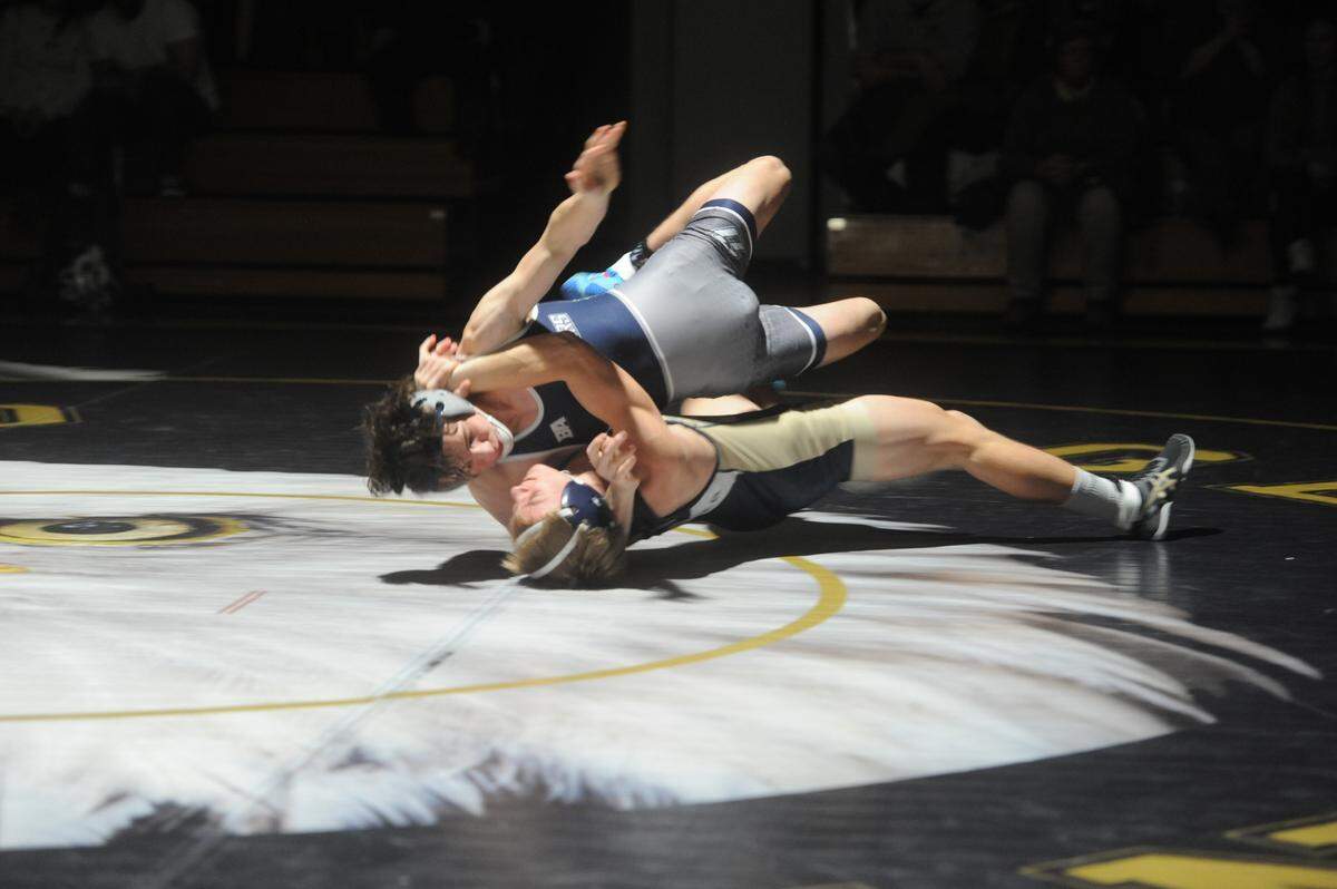 Bald Eagle Area’s Kevin Taylor rolls Philipsburg-Osceola’s Scott Frantz over to collect nearfall points in their 132-pound bout during the Eagles’ 47-15 win on Thursday, Jan. 6, 2022. Taylor beat Frantz 9-2.