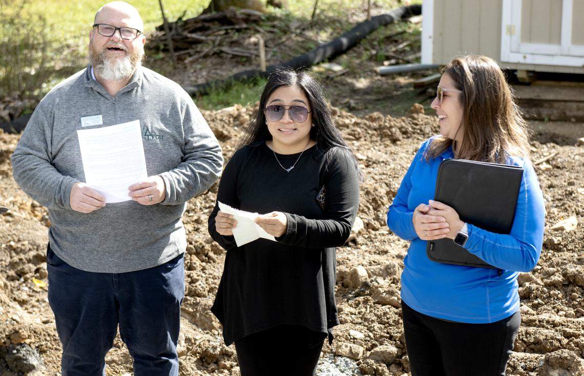 The homeowner thanks a list of people while Chad Feather and Stephanie Fost from Habitat for Humanity of Greater Centre County stand with her during a groundbreaking in Boalsburg on Wednesday, Oct. 8, 2025. The home will have its walls 3D concrete printed.