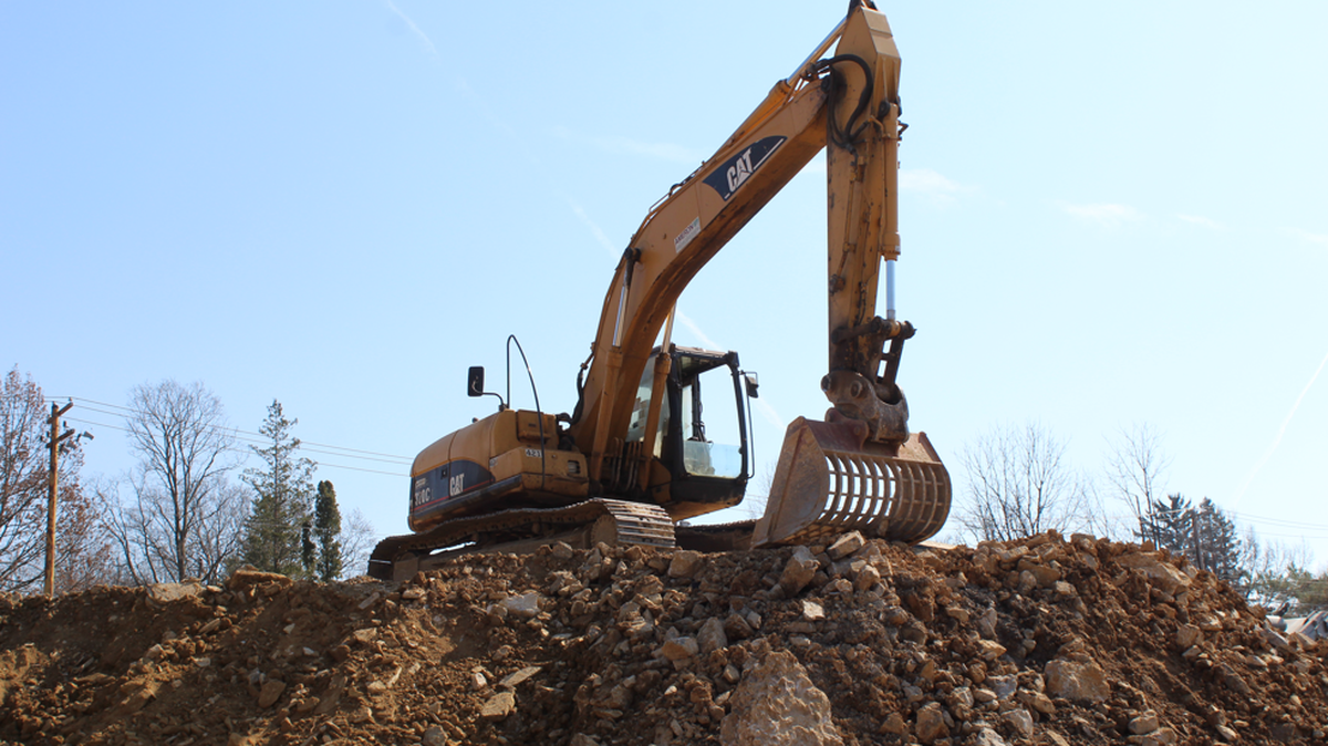 A backhoe is pictured on a pile of dirt at the site of The Retreat at Westerly, located at 462 Westerly Plaza in State College.