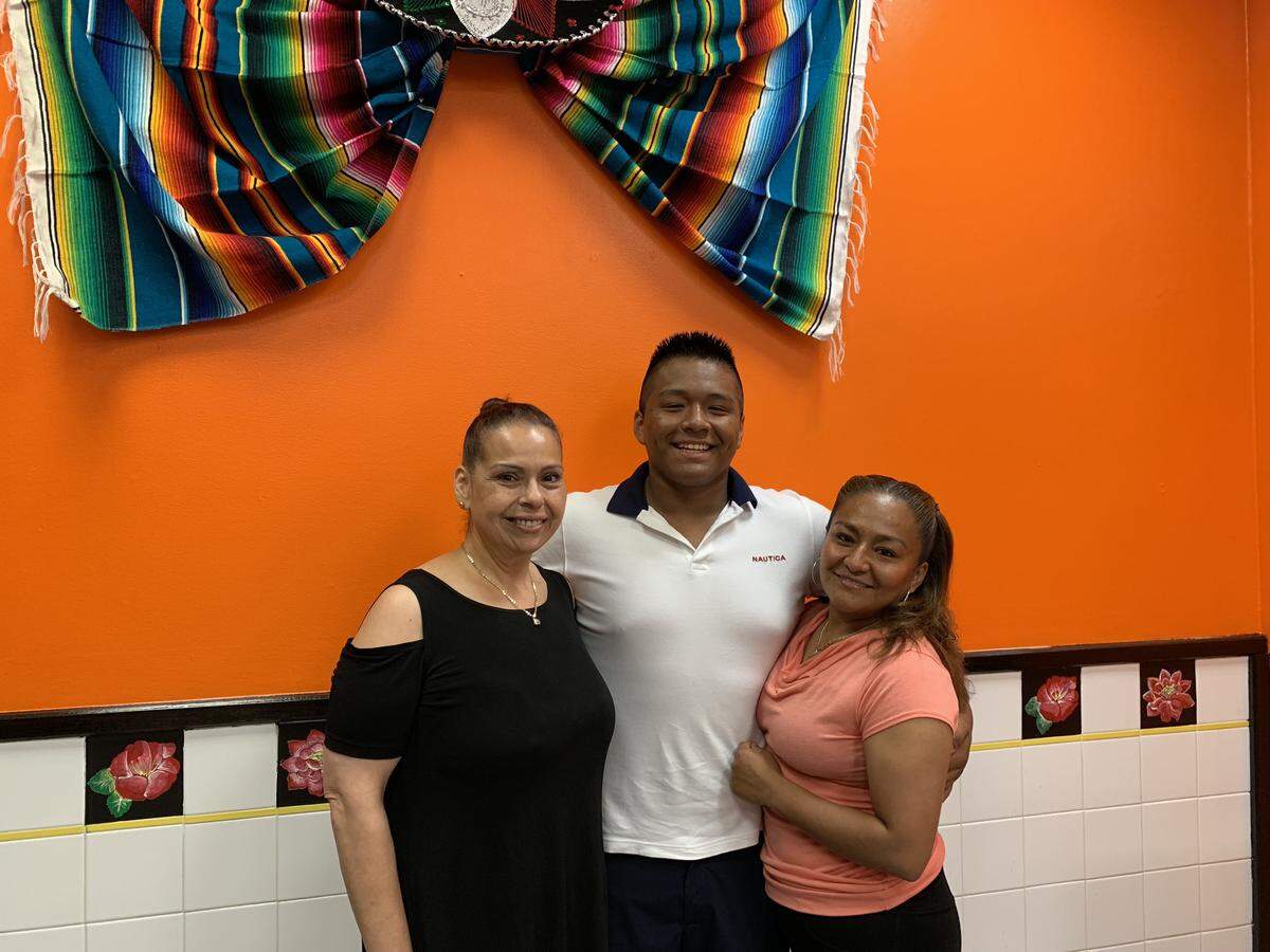 Gladys Rivera Buffamonte, Melvin Lopez Rojas and Maria Guadalupe Rojas Orozco pose inside Lupita’s Authentic Mexican Food, located inside the Uni-Mart at 3180 W. College Ave.
