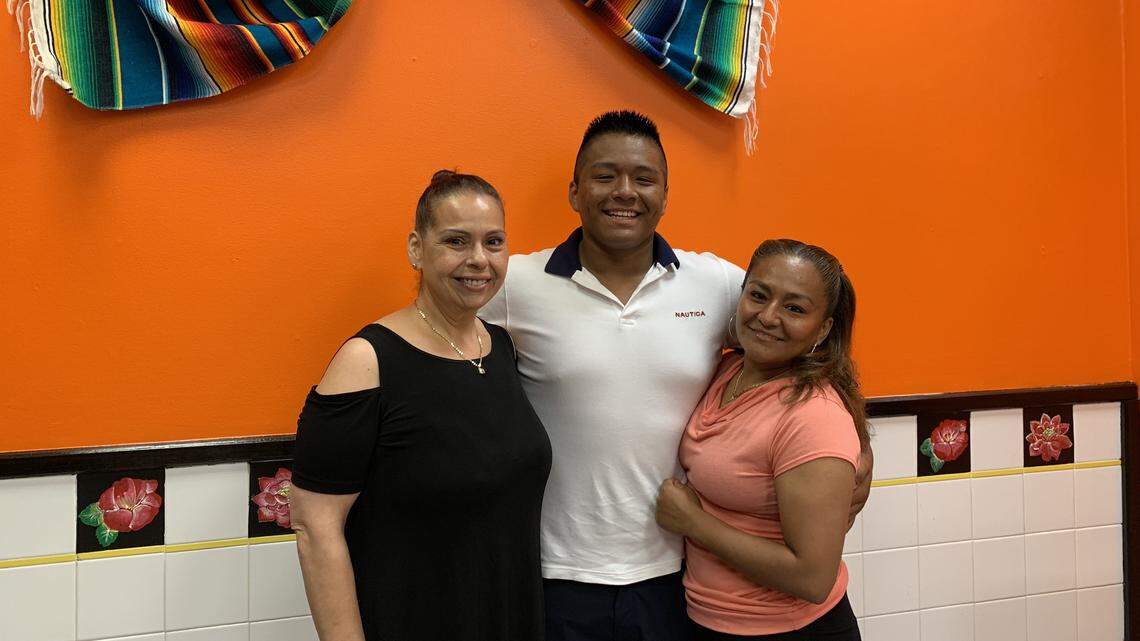 From left: Gladys Rivera Buffamonte, Melvin Lopez Rojas and Maria Guadalupe Rojas Orozco pose inside Lupita’s Authentic Mexican Food, located inside the Uni-Mart at 3180 W. College Avenue. The restaurant will host its grand opening on Saturday.