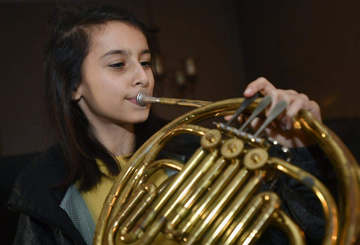 Ashley Gardner plays the French horn and the violin and composed a song on the piano that will be played by the Penn State Partners in Music Program.