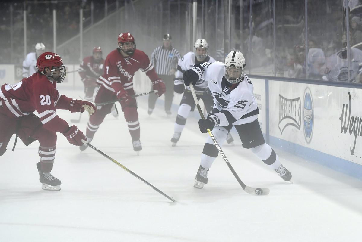 Penn State’s Denis Smirnov skates down the ie with the puck ahead of a Wisconsin defender during the game at Pegula Ice Arena on Thursday, Oct. 31, 2019. A haze came off the ice during the game.