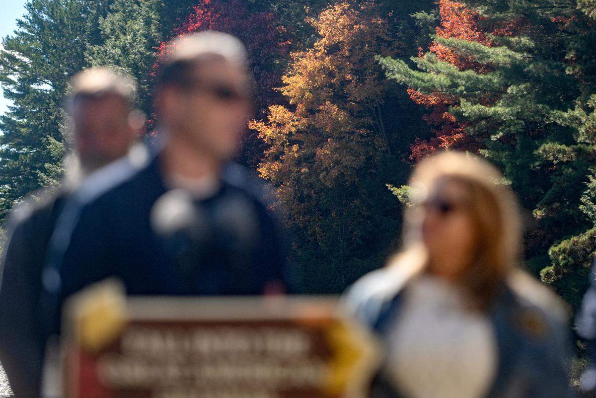 Over Pennsylvania Governor Josh Shapiro’s shoulder, colorful leaves are seen on the trees at Black Moshannon State Park on Wednesday, Oct. 9, 2024.