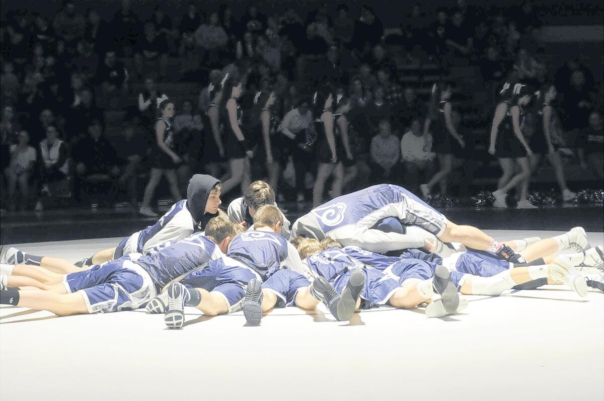 Penns Valley’s wrestling team huddles up before the Rams’ 59-21 win over Southern Huntingdon on Friday night.