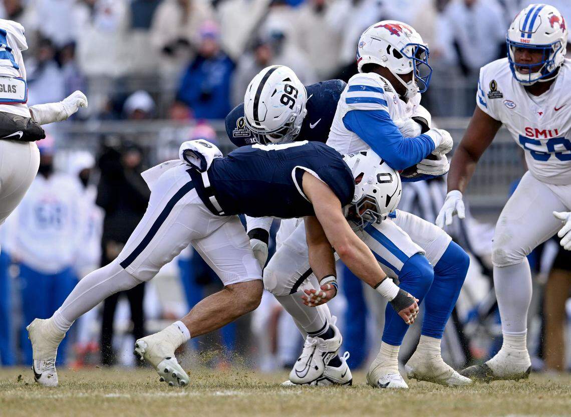 Penn State linebacker Dominic DeLuca and defensive tackle Coziah Izzard stop SMU running back Brashard Smith during the game on Saturday, Dec. 21, 2024 at Beaver Stadium.