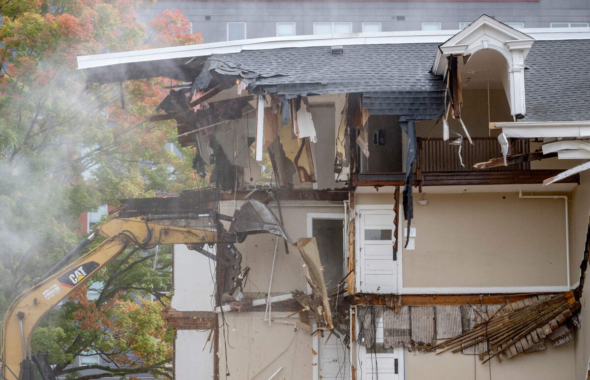 Water is sprayed to keep the dust down as workers demolish the old University Club on College Avenue on Friday, Sept. 30, 2022.