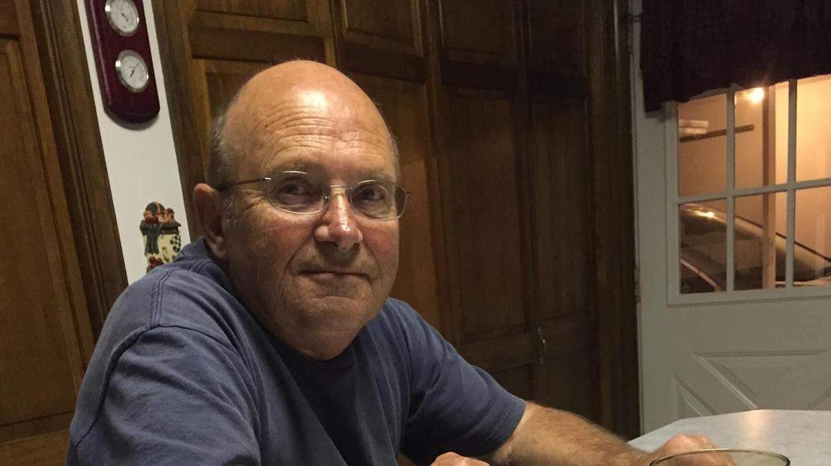 Andrew F. Swarm, 76, was killed in an April 2023 crash. In this undated photo, he sits at his home’s kitchen island.