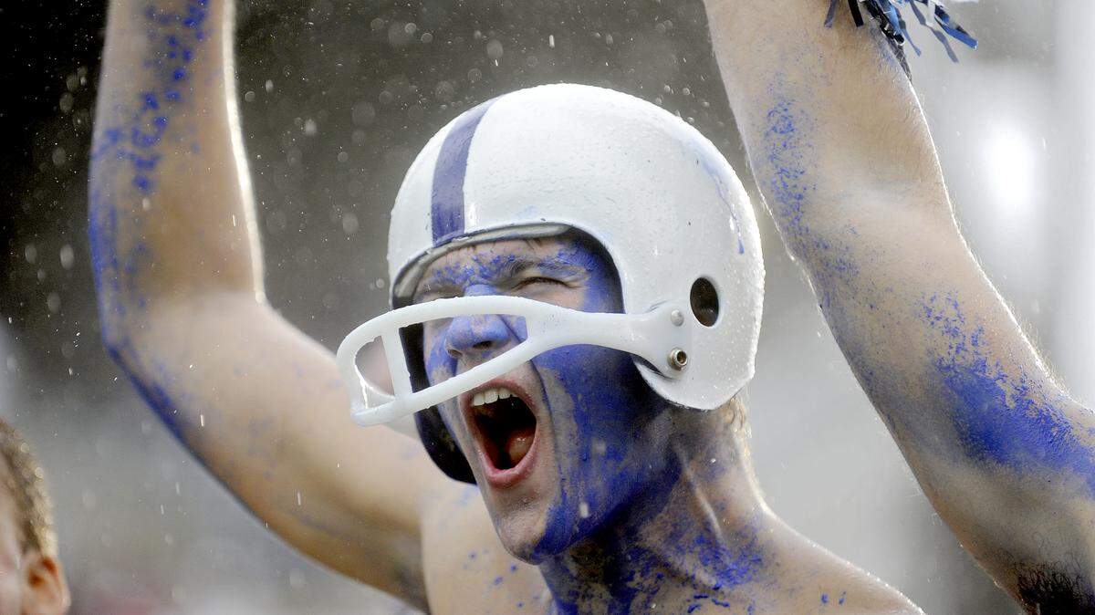 Fans cheer for Penn State through the rain during the Saturday, September 21, 2013 game against Kent State.  