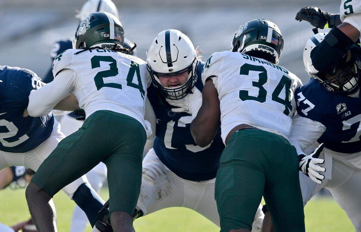 Penn State offensive lineman Mike Miranda blocks Michigan State defenders during a field in the game on Saturday, Dec. 12, 2020 at Beaver Stadium.