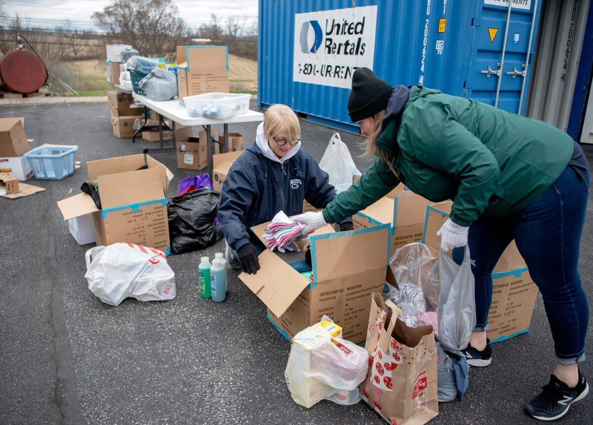Volunteers and Salvation Baptist Church members work together Friday to pack boxes full of food, toiletries, clothes and more to be sent to families in Ukraine.