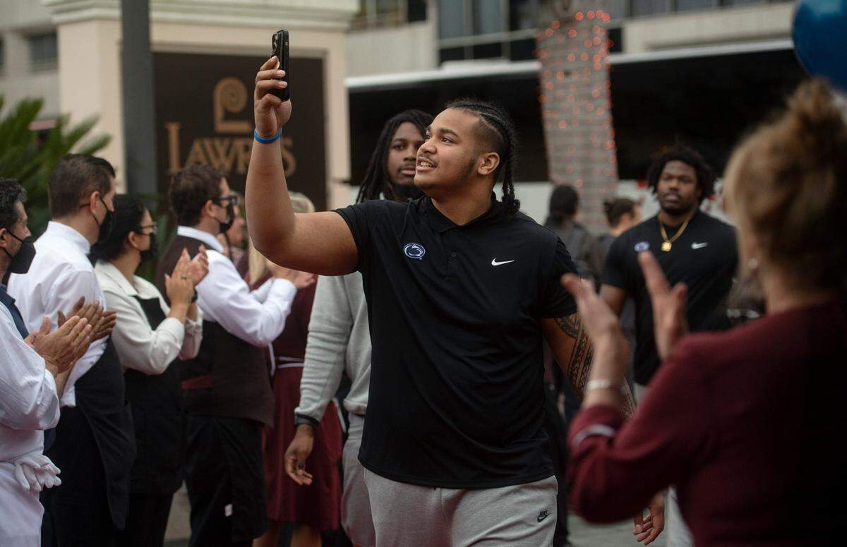Penn State defensive tackle Dvon Ellies takes video as he and his teammates are welcomed by the staff to the Lawry’s Beef Bowl on Friday, Dec. 30, 2022.