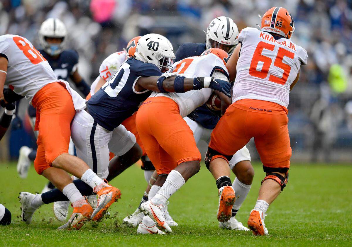 Penn State linebacker Jesse Luketa tries to stop Illinois running back Josh McCray during the game on Saturday, Oct. 23, 2021.