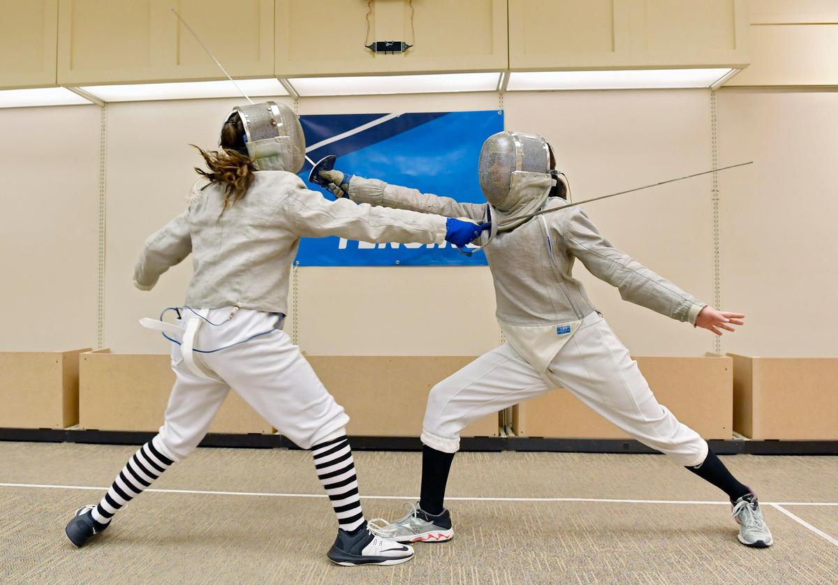 Ava Calistri, 15, and Fiona Combs, 17, practice sabre at the Nittany Fencing Academy on Tuesday, Dec. 17, 2019. The academy recently moved to a space in the Nittany Mall.