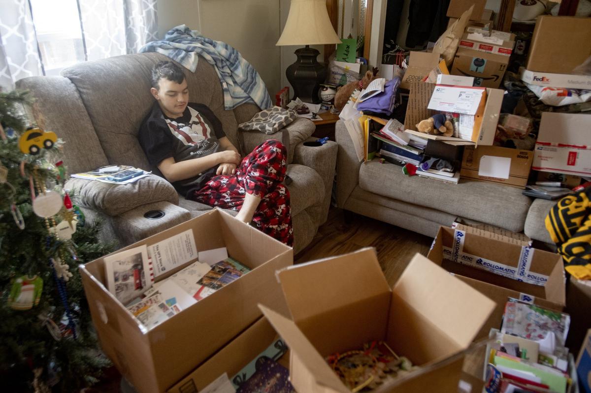 Maddox Hyde dozes off as he sits among the thousands of cards and packages he’s received on Thursday, Dec. 20, 2018.