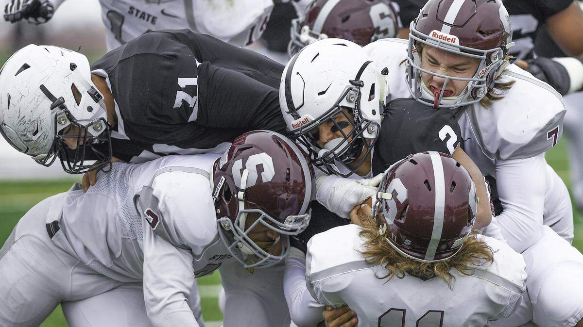 The Little Lion defenders close in on Delaware Valley’s Jay Henderson in the first round to the PIAA 6A championships at Danville High School. State College’s tacklers are Sammy Knipe (7) and Thomas Bucha (11), with Cohen Russell (2) assisting.