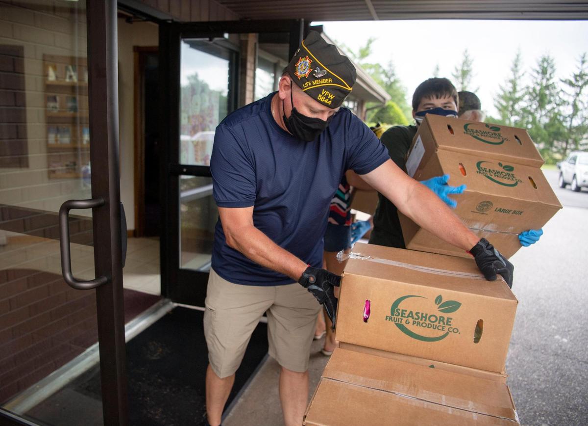 Snow Snow VFW post commander is Mike Guenot helps to distribute food at on Thursday, July 23, 2020.