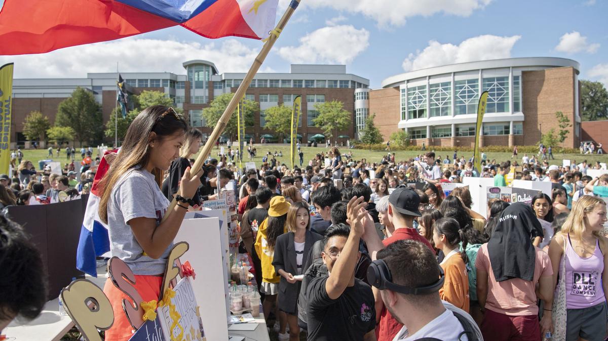 Danielle Laureta holds a flag to promote the Penn State Filipino Association at the Involvement Fair on Thursday, August 29, 2019 on the HUB lawn.