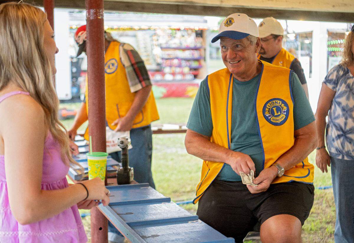 Jerry Hefferan from the Snow Shoe Lions Club laughs with community members as they play chuck-a-luck at the Snow Shoe Carnival on Tuesday, June 18, 2024.