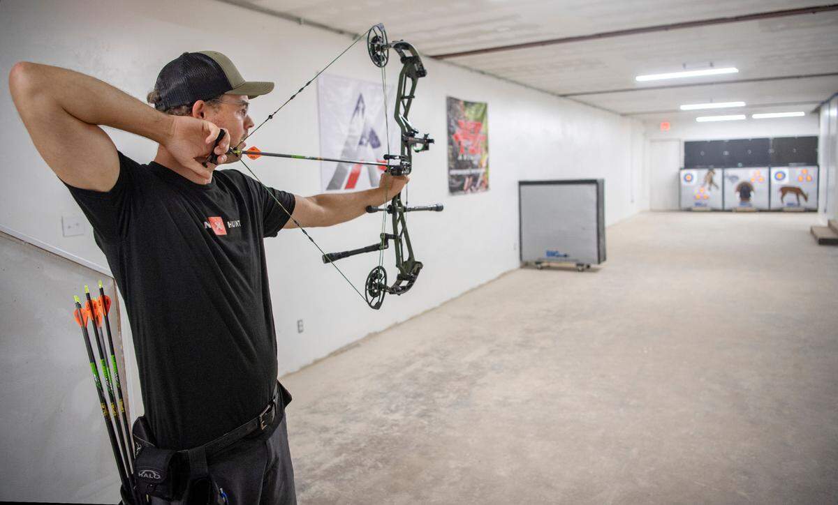 Nate Sellers of the Average Jack Archery takes a few practice shots in the range of the new Philipsburg shop on Tuesday, July 5, 2022.