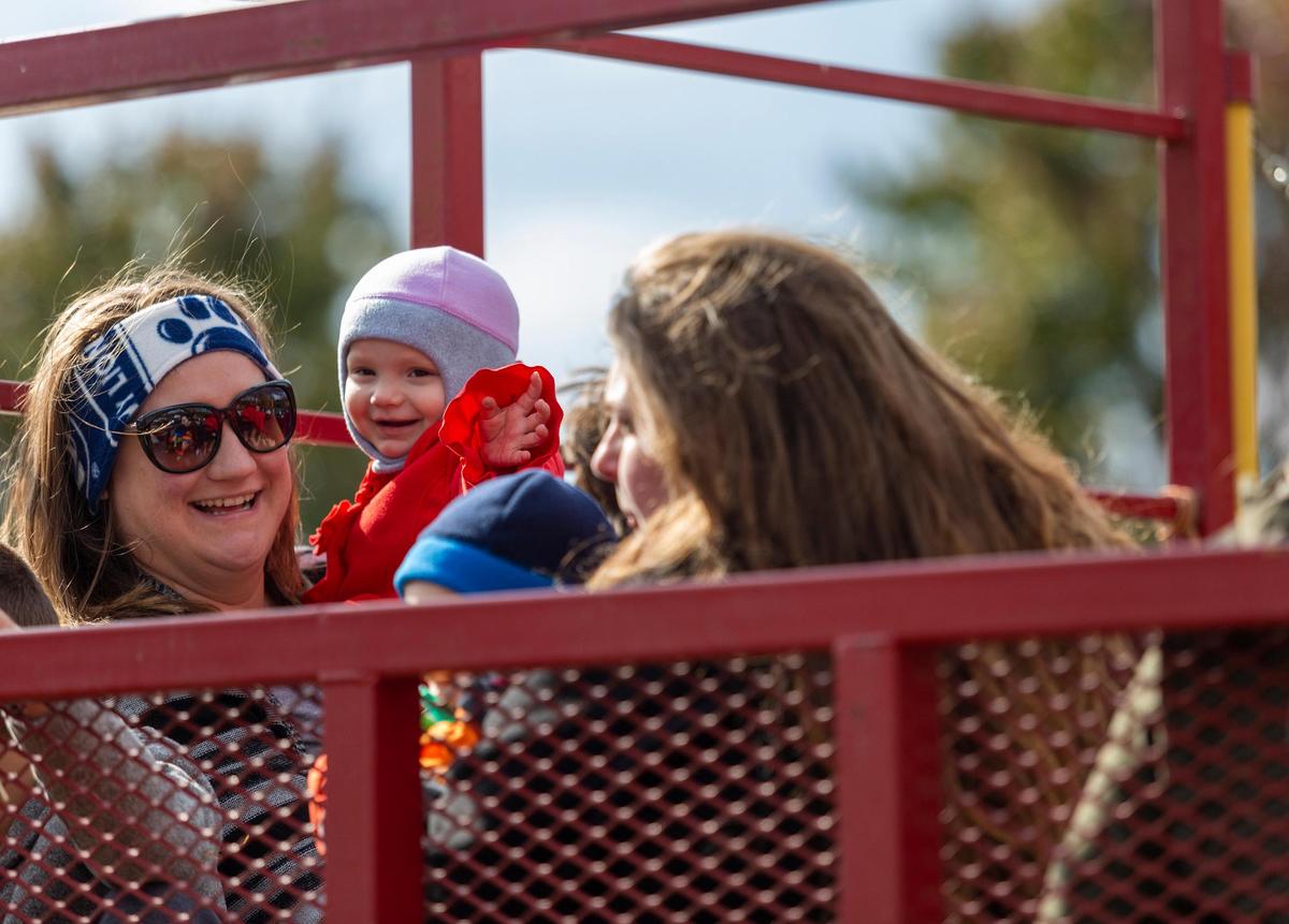 Eve Fida, 18 months, laughs as she is held by her mother, Katherine Fida, of Lewistown, as they ride on the hay ride during the 8th annual Punkin’ Chunkin’ hosted by Howard Fire Department at Bald Eagle State Park on Saturday, Oct. 20, 2018.