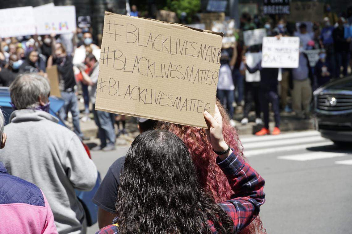 Protesters carried handmade signs and chanted for justice for George Floyd Sunday in downtown State College.