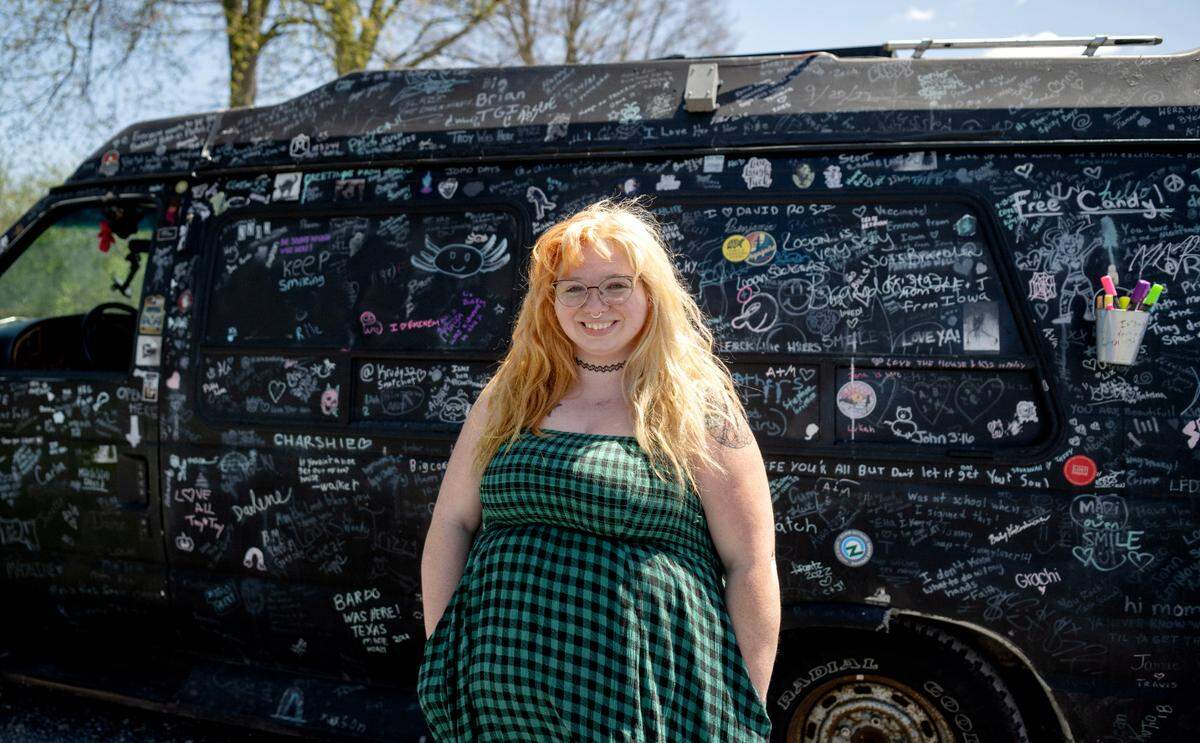 Trie’sena Brown stands with her van that is covered in signatures and messages on Monday, April 22, 2024.