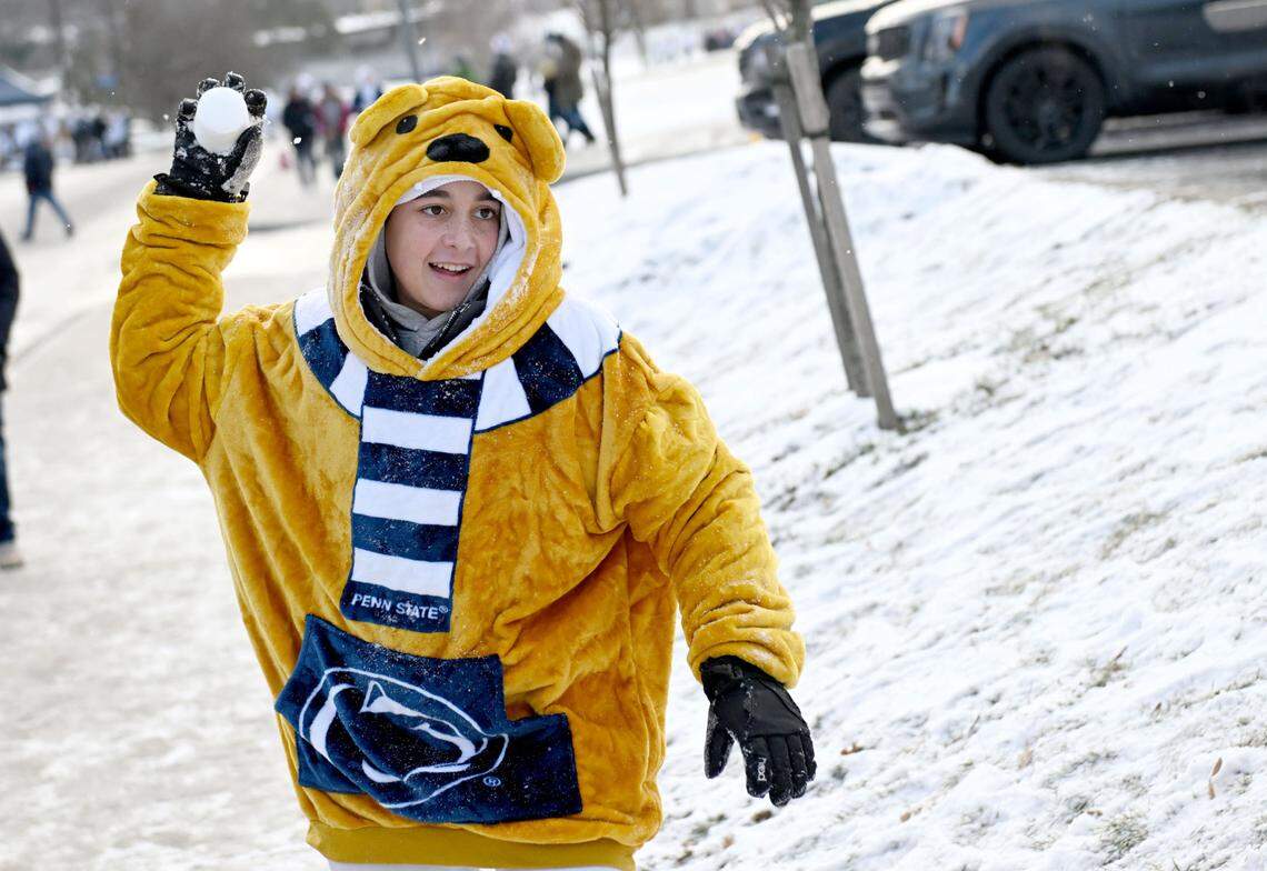 Pierce Lamichane throws a snow ball at his friend as they tailgate outside of Beaver Stadium before the CFP first round game between Penn State and SMU on Saturday, Dec. 21, 2024.