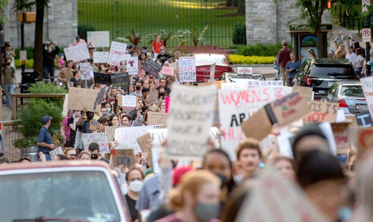 People chant as they march up Allen Street in State College protesting the Roe reversal on Friday, June 24, 2022.