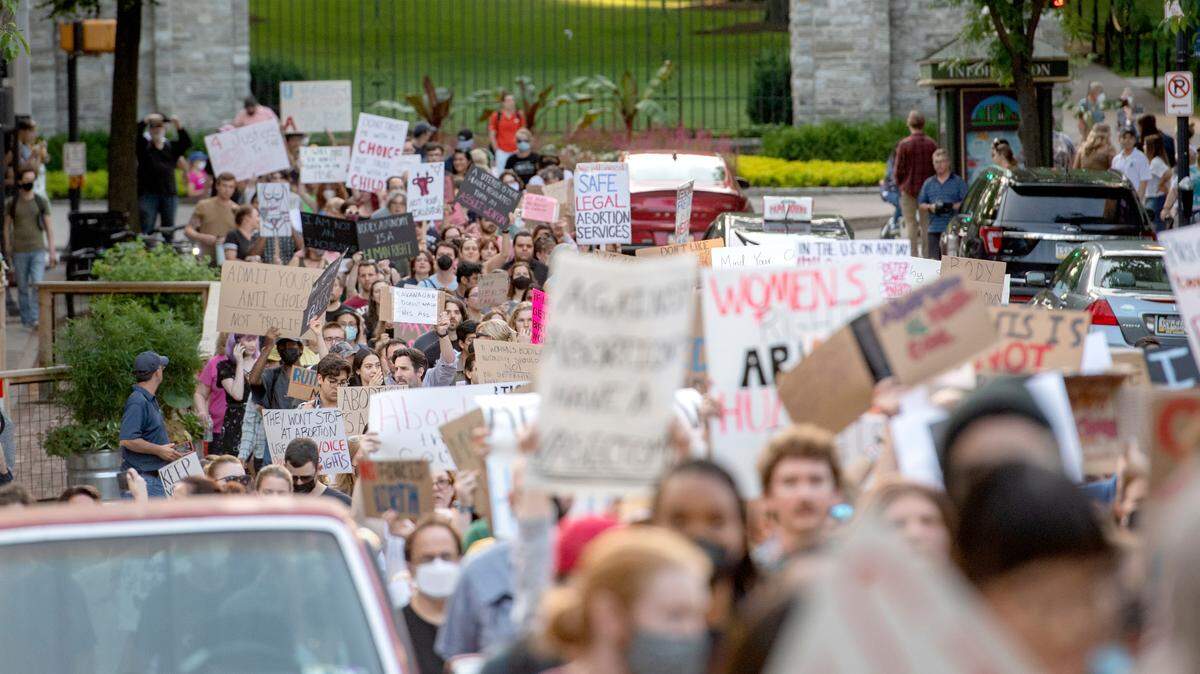 People chant as they march up Allen Street in State College protesting the Roe reversal on Friday, June 24, 2022.