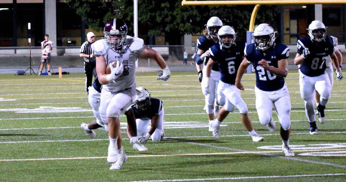 State College receiver Nathan Lusk (84) gains 39 yards on a pass play in the first half at Chambersburg. 