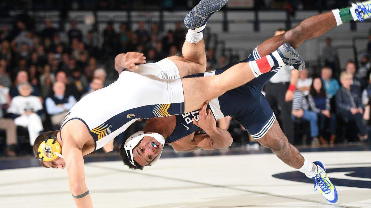 Penn State’s Mark Hall, 174 lbs, takes down Kent State’s Dylan Barreiro enroute to a pin Sunday at Rec Hall in State College. Penn State defeated Kent State, 52-3.