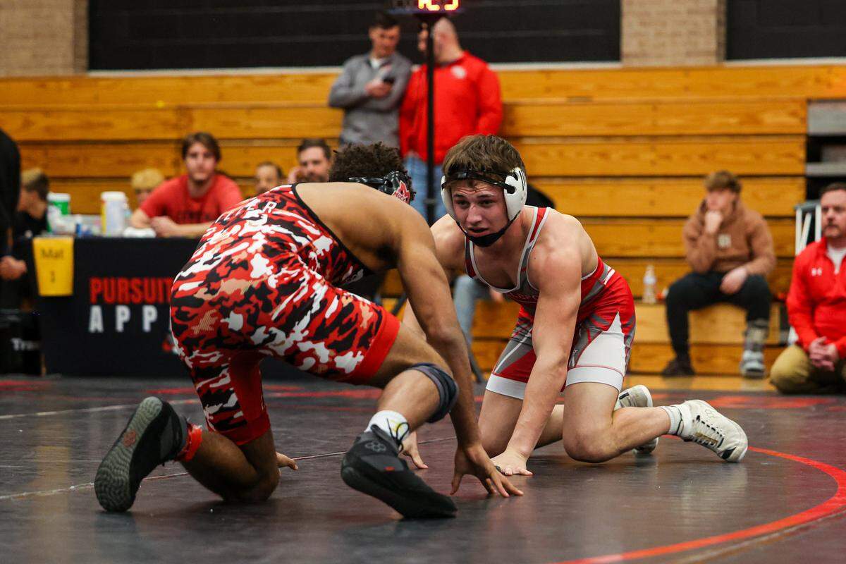 Bellefonte’s Noah Weaver looks for an opening on Bishop McCort’s Melvin Miller in their 160-pound finals match of the Laurel Highlands Athletic Conference championships on Saturday at Central Cambria High School in Ebensburg. Miller beat Weaver, 21-6, in 2:00.
